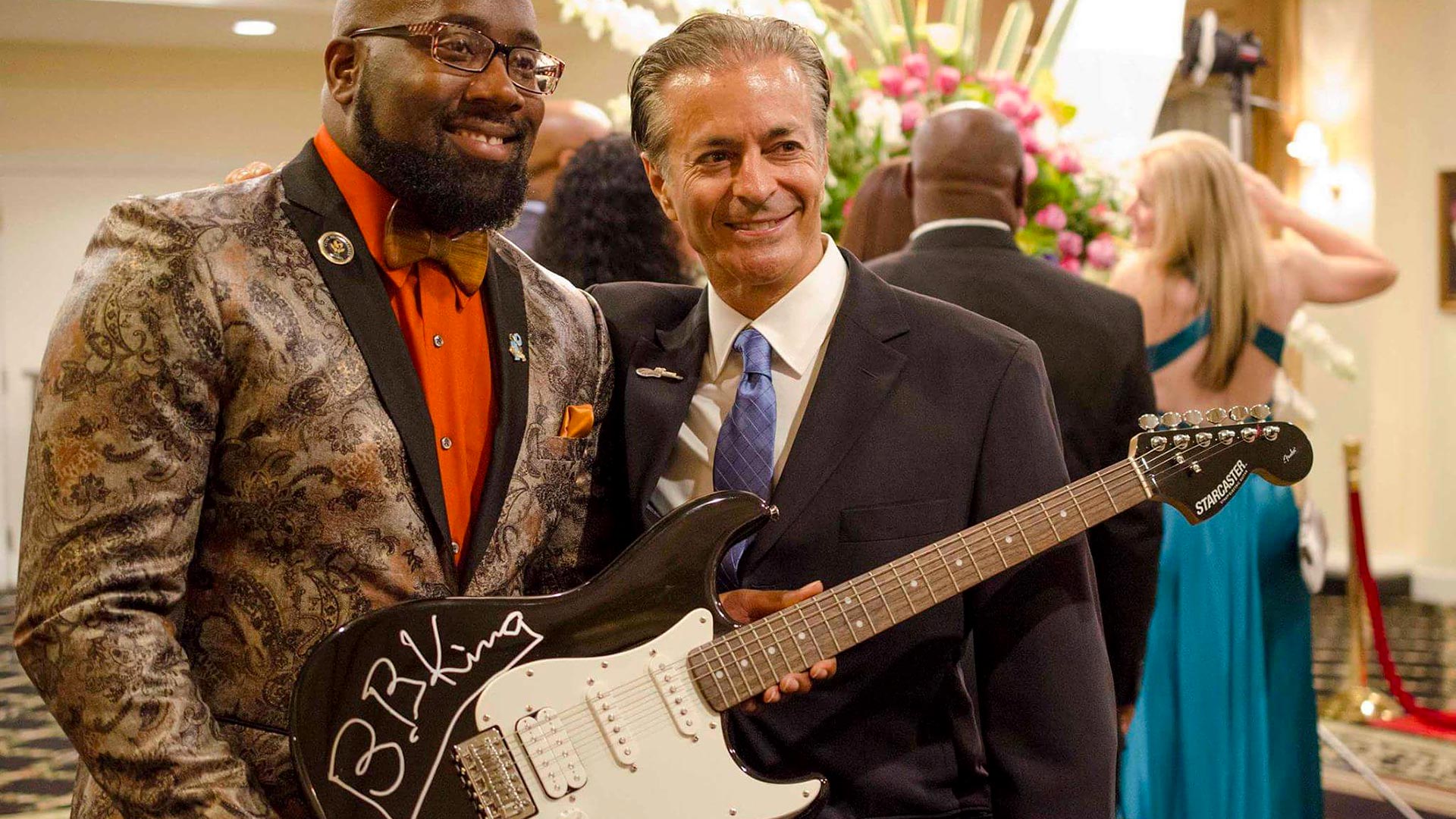 2 men with a guitar at an event run by SociallyFunded