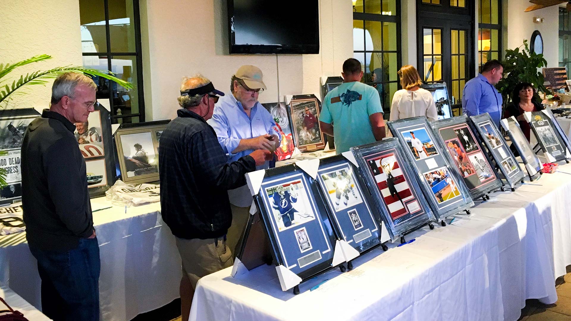 People looking at items at an event run by SociallyFunded