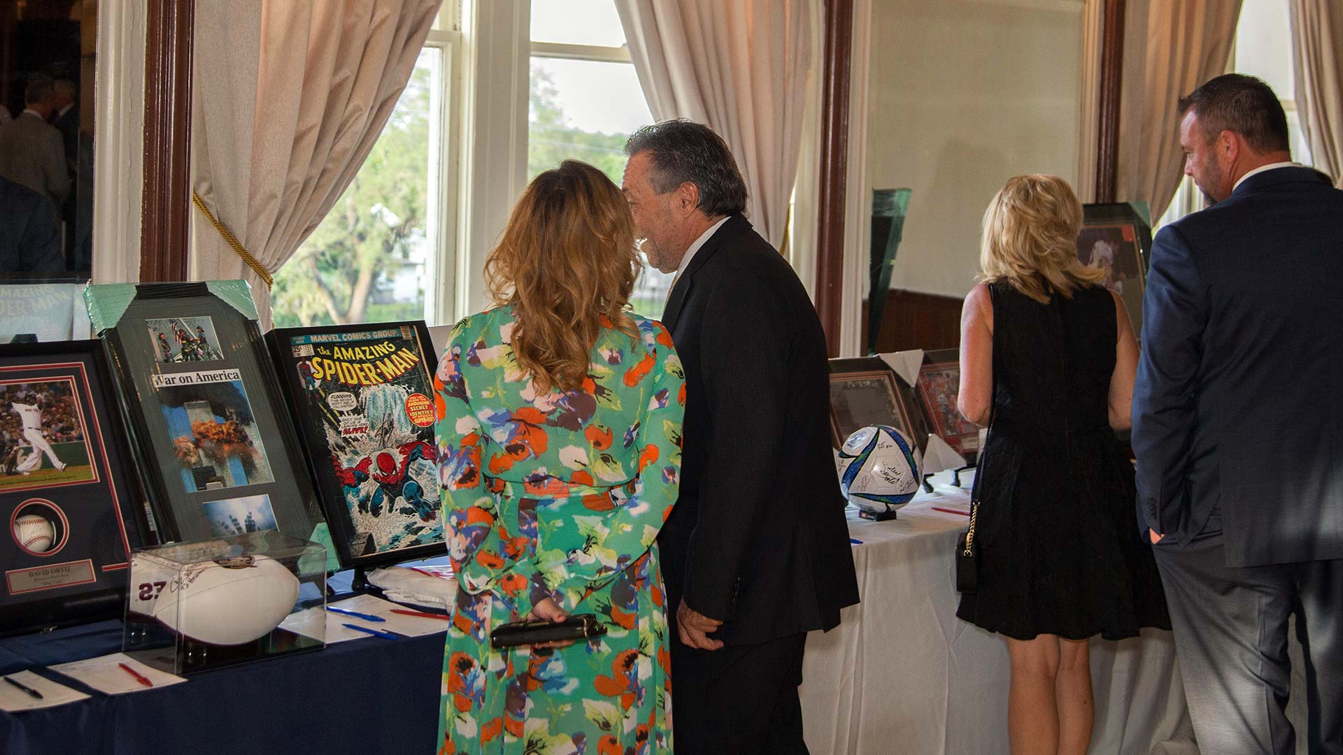 Two people looking at items at an event run by SociallyFunded